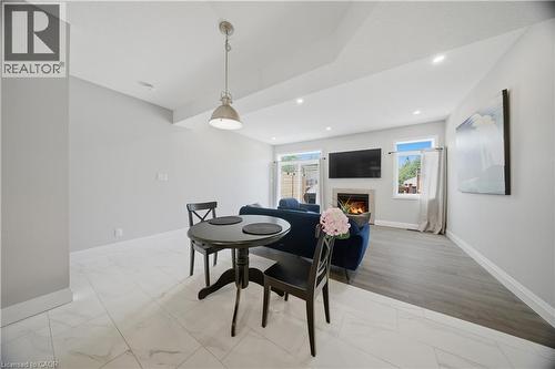 Open-concept living space featuring a fireplace, recessed lighting, and a neutral color palette - 107 Stephenson Way, Palmerston, ON - Indoor Photo Showing Dining Room With Fireplace