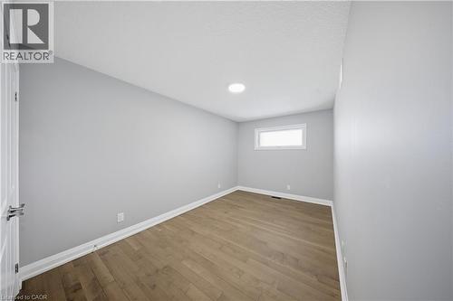 Room featuring wood-finish flooring, recessed lighting, and a single horizontal window - 107 Stephenson Way, Palmerston, ON - Indoor Photo Showing Other Room
