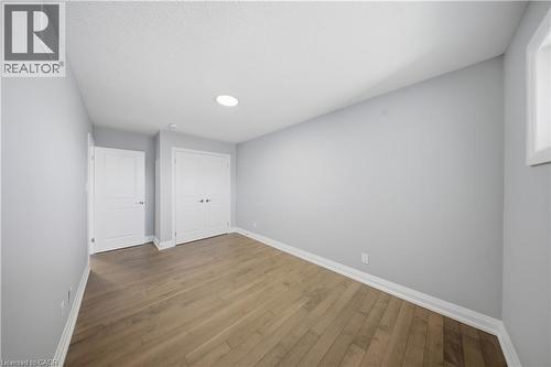 Room featuring wood-finish flooring, light gray wall paint, and recessed lighting - 107 Stephenson Way, Palmerston, ON - Indoor Photo Showing Other Room