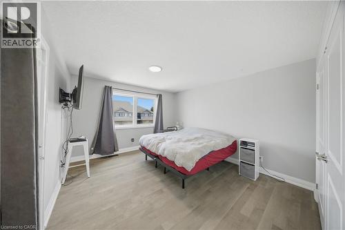 Spacious room featuring wood-finish flooring, light grey painted walls, and a recessed ceiling light - 107 Stephenson Way, Palmerston, ON - Indoor Photo Showing Bedroom