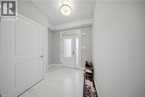 Bright entryway featuring white paneled doors, white baseboards, and light gray walls - 107 Stephenson Way, Palmerston, ON - Indoor Photo Showing Other Room