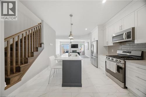 Contemporary kitchen with white cabinetry, stainless steel appliances, and light-toned countertops - 107 Stephenson Way, Palmerston, ON - Indoor Photo Showing Kitchen With Stainless Steel Kitchen With Upgraded Kitchen