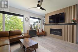 Custom wood slat feature wall around gas fireplace - 