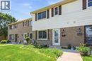 Brick facade with light-colored siding, contrasting brown shutters, and multiple windows - 86 San Remo Drive, Hamilton, ON  - Outdoor With Exterior 