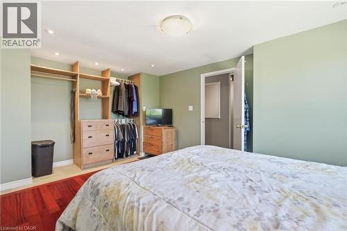 Integrated custom closet system featuring shelving, hanging rods, and built-in drawers - 86 San Remo Drive, Hamilton, ON - Indoor Photo Showing Bedroom