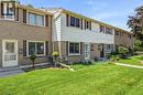 Brick and siding exterior featuring multiple windows with shutters and mature front lawn - 86 San Remo Drive, Hamilton, ON  - Outdoor 