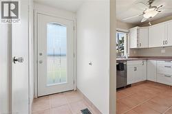 Entryway featuring tile flooring and a decorative glass front door - 