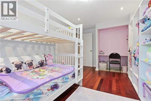 Bedroom featuring built-in bunk beds, rich wood-finish flooring, recessed lighting, and a dedicated desk alcove - 86 San Remo Drive, Hamilton, ON - Indoor Photo Showing Bedroom