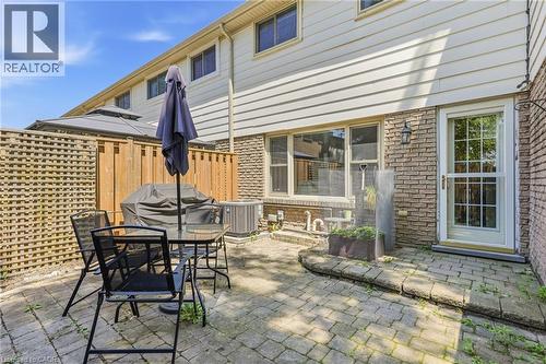 Paved patio area featuring brick and siding exterior - 86 San Remo Drive, Hamilton, ON - Outdoor With Deck Patio Veranda