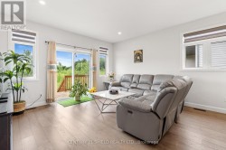 Behind the couch, could be a dining area. - 