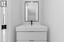 Contemporary floating vanity with integrated sink, matte black faucet, and a sleek black-framed mirror - 146 Everett Common, St. Catharines, ON  - Indoor Photo Showing Bathroom 