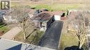 Ranch-style residence featuring a brick facade, asphalt driveway, attached garage, and a front lawn with established trees - 60 Lysanda Avenue, London, ON  - Outdoor 