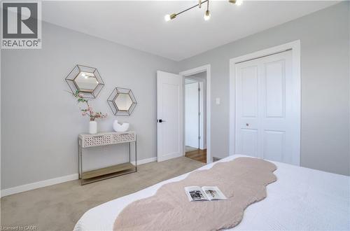 Light gray painted walls with white trim, complementing the neutral carpet flooring - 60 Lysanda Avenue, London, ON - Indoor Photo Showing Bedroom