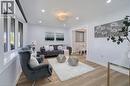 Expansive living area featuring light wood-finish flooring, recessed lighting, and a crystal chandelier - 60 Lysanda Avenue, London, ON  - Indoor Photo Showing Living Room 