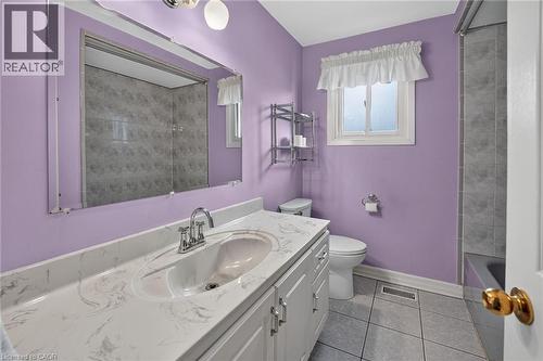 Bathroom vanity featuring a single basin, a chrome faucet, and a patterned countertop - 186 Glenmor Drive, Caledonia, ON - Indoor Photo Showing Bathroom