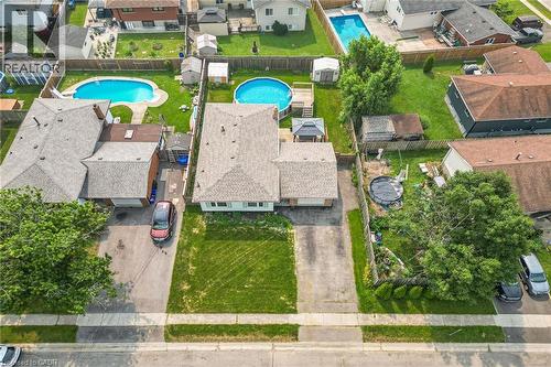 Aerial view of a residential property featuring a gray shingle roof and an extensive rear yard - 186 Glenmor Drive, Caledonia, ON - Outdoor With Above Ground Pool With View