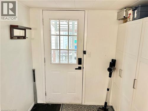 White paneled door with windowpanes, flanked by white walls - 88 Brook Street, Simcoe, ON - Indoor Photo Showing Other Room