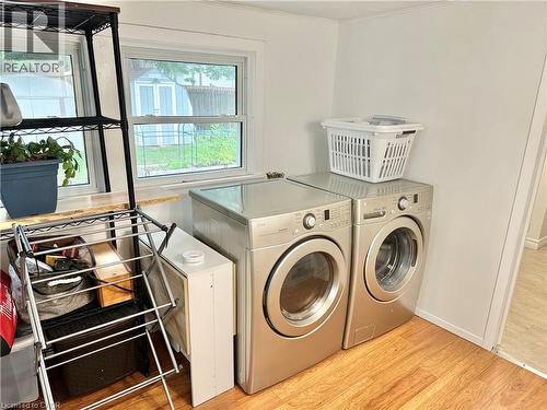 Dedicated laundry area featuring wood-finish flooring and white walls - 88 Brook Street, Simcoe, ON - Indoor Photo Showing Laundry Room