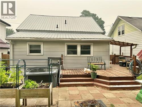 Rear exterior featuring light-colored siding and a metal roof - 88 Brook Street, Simcoe, ON - Outdoor With Exterior