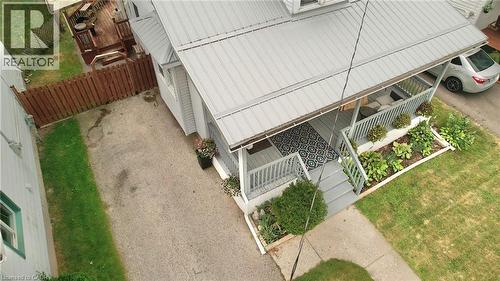 Front facade featuring a covered porch, metal roof, and established landscaping - 88 Brook Street, Simcoe, ON - Outdoor