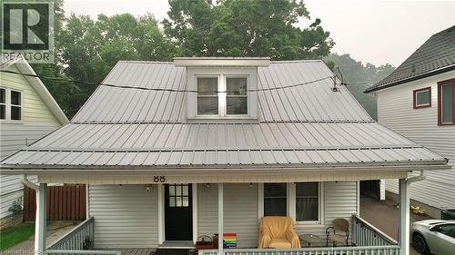 Siding exterior featuring a covered porch, white trim, and a prominent metal roof - 88 Brook Street, Simcoe, ON - Outdoor With Deck Patio Veranda With Exterior