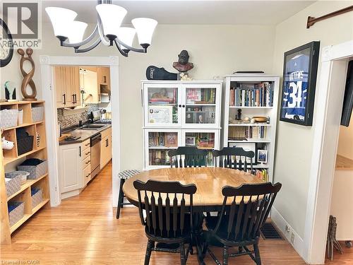 Dining area featuring wood-finish flooring and a central chandelier - 88 Brook Street, Simcoe, ON - Indoor Photo Showing Dining Room