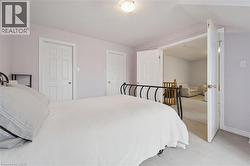 Interior space featuring light purple walls, a textured white ceiling, and light-colored carpet flooring - 