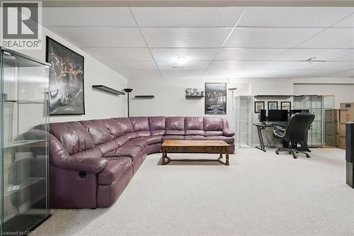 Spacious carpeted room featuring a drop ceiling with recessed lighting, white walls, and a dedicated desk area - 23 Knack Lane, Cambridge, ON - Indoor