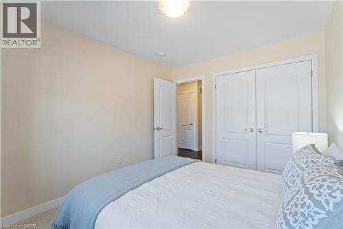 Neutral-toned room featuring a single overhead light fixture, light-colored walls, and white baseboards - 10 Lemon Avenue, Thorold, ON - Indoor Photo Showing Bedroom