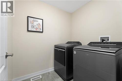 Dedicated laundry area featuring tile flooring, neutral wall tones, and white baseboards - 10 Lemon Avenue, Thorold, ON - Indoor Photo Showing Laundry Room
