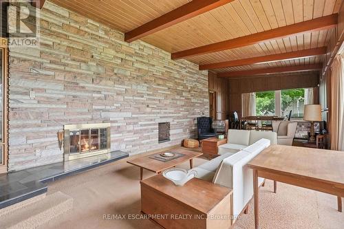 Liv space featuring full-height stacked stone wall - 264 Mountain Brow Boulevard, Hamilton, ON - Indoor Photo Showing Living Room With Fireplace