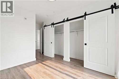 Interior space featuring wood-finish flooring, white walls, and a recessed ceiling light - 50 Grand Avenue S Unit# 713, Cambridge, ON - Indoor Photo Showing Other Room