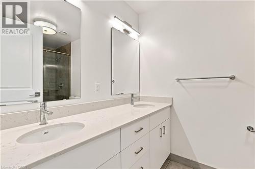 Dual vanity featuring white cabinetry, undermount sinks, and light-toned countertops - 50 Grand Avenue S Unit# 713, Cambridge, ON - Indoor Photo Showing Bathroom