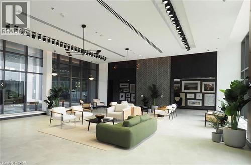 Spacious interior featuring high ceilings, extensive window walls, and light-toned flooring - 50 Grand Avenue S Unit# 713, Cambridge, ON - Indoor