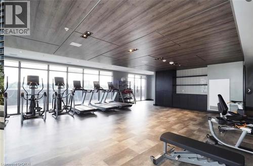 Fitness room featuring full-height windows, wood-finish flooring, and a paneled ceiling - 50 Grand Avenue S Unit# 713, Cambridge, ON - Indoor Photo Showing Gym Room
