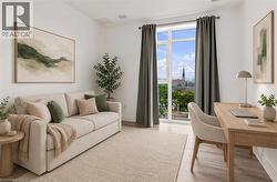 Light-filled room featuring large windows, wood-finish flooring, and white walls - 