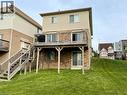 Rear elevation featuring a multi-level wood deck with black metal railings, a ground-level patio door, and a brick and siding exterior - 287 Westmeadow Drive, Kitchener, ON  - Outdoor With Deck Patio Veranda 