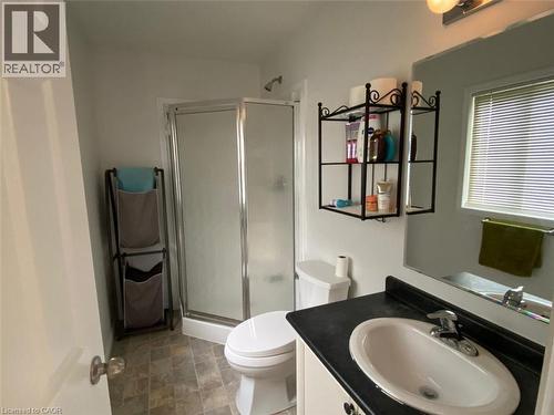 Bathroom featuring an enclosed shower, a single vanity with an integrated sink, a wall-mounted mirror, and a window with blinds - 287 Westmeadow Drive, Kitchener, ON - Indoor Photo Showing Bathroom