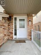 Inviting front entrance featuring a white panel door with glass inserts, sidelight, and an overhead soffit - 