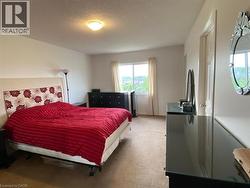 Room featuring a large window with outdoor scenery, neutral-toned walls, and a ceiling-mounted light fixture - 