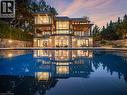 Multi-level property featuring stone and stucco exterior, extensive glass paneling, and multiple balconies with glass railings - 140 Secord Lane, Burlington, ON  - Outdoor With In Ground Pool 