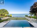 Infinity-edge swimming pool with integrated steps and a surrounding stone patio - 140 Secord Lane, Burlington, ON  - Outdoor With Body Of Water With In Ground Pool With View 