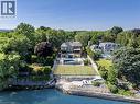 Waterfront property featuring a tennis court, in-ground swimming pool, and stone retaining walls - 140 Secord Lane, Burlington, ON  - Outdoor With Body Of Water With View 
