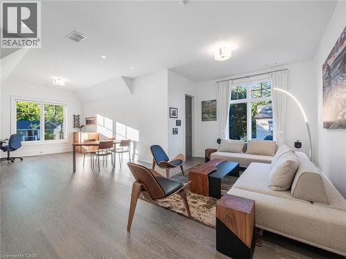 Bright open-concept living area featuring light wood-finish flooring, white walls, multiple windows, recessed lighting, and a vaulted ceiling - 140 Secord Lane, Burlington, ON - Indoor Photo Showing Living Room