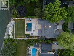 Expansive property featuring a tennis court, swimming pool, and stone patio - 