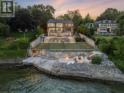 Waterfront property featuring a multi-level terraced landscape with stone retaining walls - 