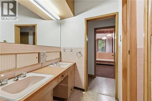 Bathroom featuring a dual vanity with integrated sinks, wood-finish cabinetry, and full-width mirror - 264 Mountain Brow Boulevard, Hamilton, ON - Indoor
