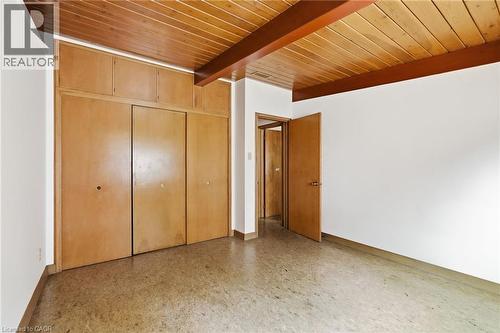 Room featuring a wood-panel ceiling with exposed beams, light wood-finish built-in cabinetry, and neutral-toned flooring - 264 Mountain Brow Boulevard, Hamilton, ON - Indoor Photo Showing Other Room