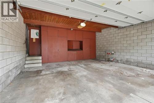 Spacious garage featuring concrete block walls, a concrete floor, and a wooden slat ceiling with exposed beams - 264 Mountain Brow Boulevard, Hamilton, ON - Indoor Photo Showing Garage