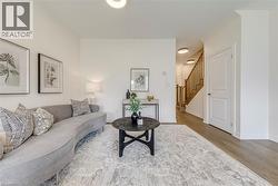 Bright living area featuring light wood-finish flooring and a neutral color palette - 